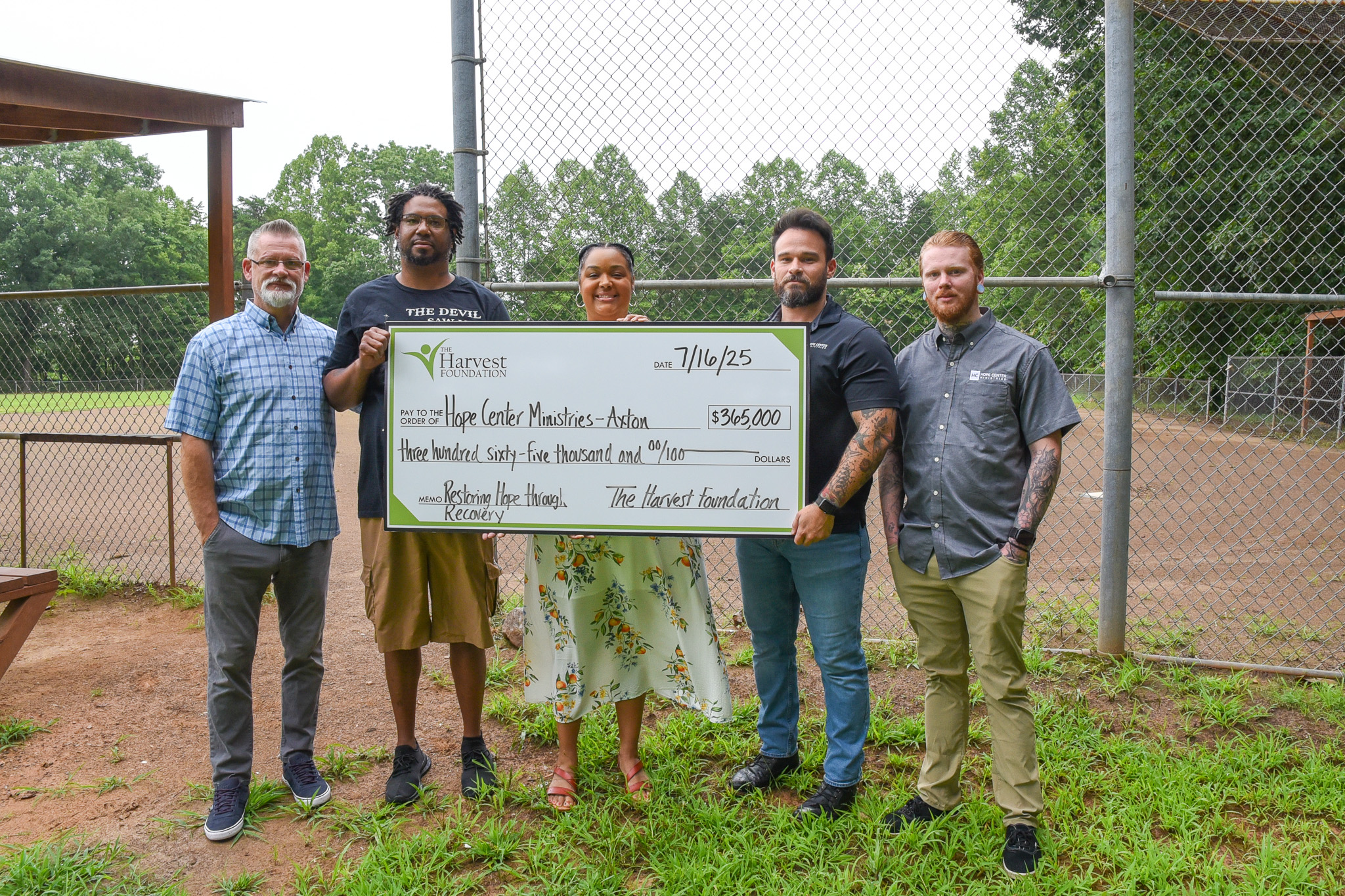 people standing with a large ceremonial check